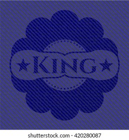 King badge with denim background
