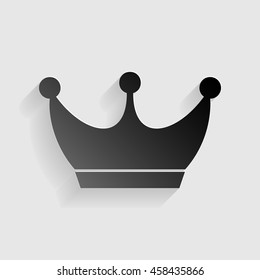 King crown sign. Black paper with shadow on gray background.