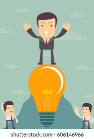King of the world, young successful businessman proudly standing on the top. Happy man celebrating his success With the idea in light bulb.