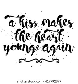 A kiss makes the heart young again. Written calligraphy. Brush painted letters. Hand drawn inspiration quote about affection, friendship, care and love in people relationships. 