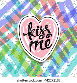 Kiss me, hand-drawn letters with a heart on bright background