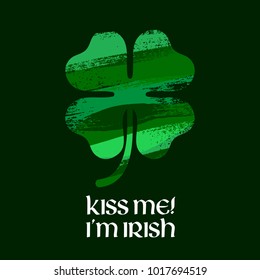 Kiss me I'm Irish message illustration. St Patrick's day design with green paintbrush smudges clover shamrock.