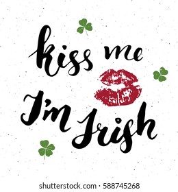 Kiss me, I'm irish. St Patrick's Day greeting card Hand lettering with lips and clovers, Irish holiday brushed calligraphic sign vector illustration