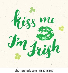 Kiss me, I'm irish. St Patrick's Day greeting card Hand lettering with lips and clovers, Irish holiday brushed calligraphic sign vector illustration