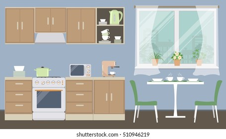 Kitchen in a blue color. There is a kitchen furniture of a beige color, a table, two green chairs, a kettle, a microwave, a coffee machine and other objects in the picture. Vector flat illustration