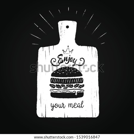  Kitchen board hand-drawn in chalk on a blackboard. Silhouette of a burger and the text "Enjoy your meal"