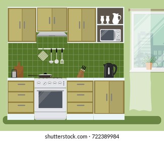 Kitchen in a green color. There is a beige furniture, a stove, a microwave, a kettle, a fragment of window and other objects in the picture. Vector flat illustration