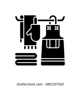 Kitchen linen black glyph icon. Apron. Dish cloths. Kitchen towels and napkins. Housekeeping. Pot holders and oven gloves. Silhouette symbol on white space. Vector isolated illustration