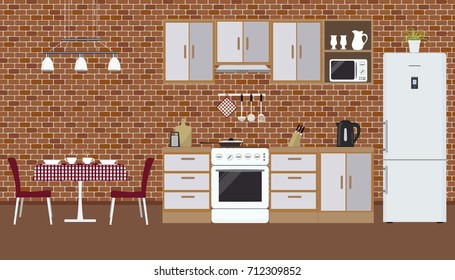 Kitchen on the brick wall background. There is a furniture, a stove, a refrigerator, a microwave, a kettle and other objects in the picture. There is also a table and chairs here. Vector illustration