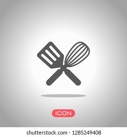 Kitchen tool icon. Whisk and spatula, criss and cross. Icon under spotlight. Gray background