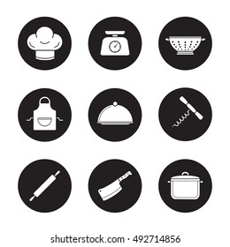 Kitchenware icons set. Chef's hat, kitchen food scales, colander, apron, covered dish, stew pot, rolling pin, cleaver, corkscrew. Vector white silhouettes illustrations in black circles