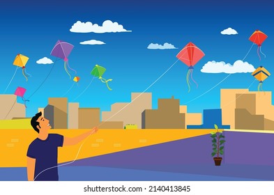 kite flying , kite festival , boy flying kite on roof top in a bright sunny day with clouds 