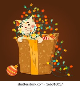 Kitten in a box with Christmas garlands.