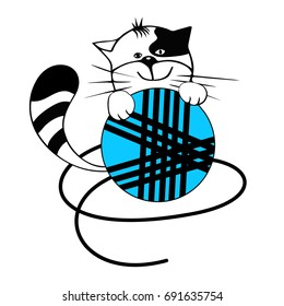 The kitten plays with a ball of threads