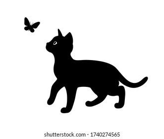 A kitten plays with a flying butterfly. Black silhouette of a cat isolated on white background. The symbol of Halloween. Can be used as a sticker template, logo element, icon for web design.
