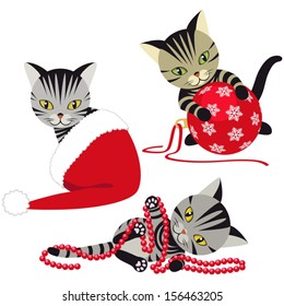 Kittens playing with Christmas decorations isolated on white