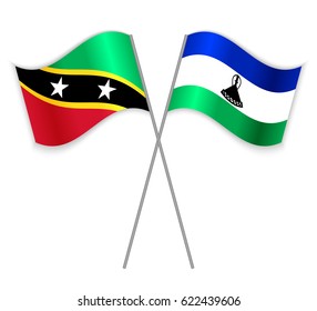 Kittitian and Basotho crossed flags. Saint Kitts and Nevis combined with Lesotho isolated on white. Language learning, international business or travel concept.