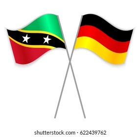 Kittitian and German crossed flags. Saint Kitts and Nevis combined with Germany isolated on white. Language learning, international business or travel concept.