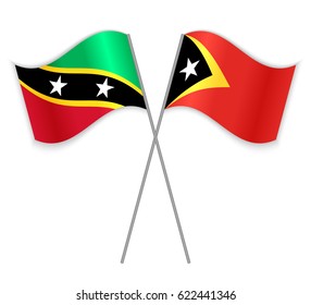 Kittitian and Timorese crossed flags. Saint Kitts and Nevis combined with East Timor isolated on white. Language learning, international business or travel concept.