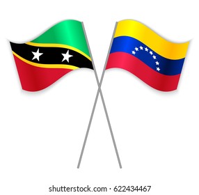 Kittitian and Venezuelan crossed flags. Saint Kitts and Nevis combined with Venezuela isolated on white. Language learning, international business or travel concept.
