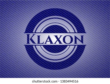 Klaxon emblem with denim high quality background. Vector Illustration. Detailed.