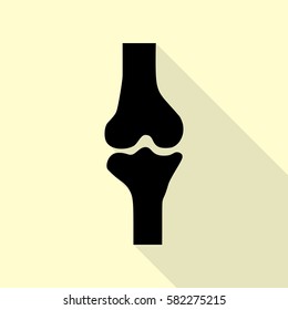 Knee joint sign. Black icon with flat style shadow path on cream background.