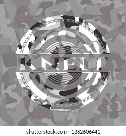 Knelt on grey camouflaged pattern