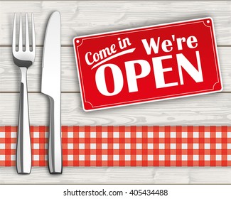 Knife and fork with checked table cloth and sign on the wooden background. Eps 10 vector file.