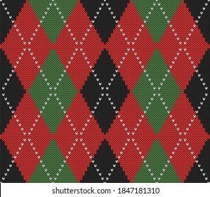 Knitted argyle Christmas and new year pattern. Wool knitinng. Scottish plaid in red, black and green rhombuses. Traditional  background of diamonds. Seamless fabric texture. Vector illustration