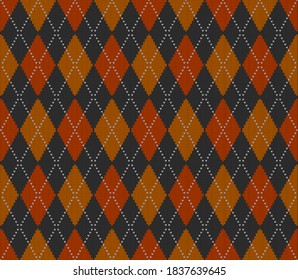 Knitted argyle Halloween pattern. Wool knitinng. Scottish plaid in orange and black rhombuses. Traditional  Scottish background of diamonds . Seamless fabric texture. Vector illustration