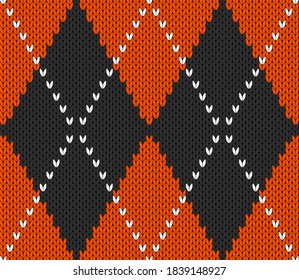 Knitted argyle Halloween pattern. Wool knitinng. Scottish plaid in orange and black rhombuses. Traditional  Scottish background of diamonds . Seamless fabric texture. Vector illustration