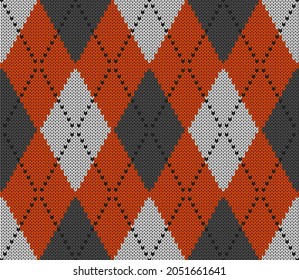 Knitted argyle Halloween pattern. Wool knitinng. Scottish plaid in orange, gray and white rhombuses. Traditional  Scottish background of diamonds . Seamless fabric texture. Vector illustration