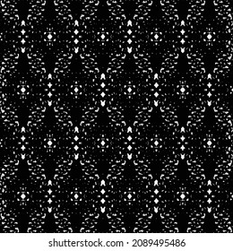 Gezwirnter Baumwollstoff mit geometrischem Muster, bestehend aus leicht länglichen, sechseckigen Formen. Schwarz-Weiß-Pullover-Textur.