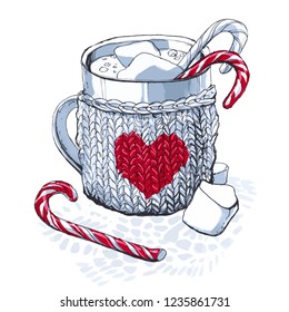 a knitted gray mug with a heart