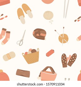Knitted items vector seamless pattern. Skein of wool, knitting needles, yarn basket, woolen mittens, hand made scarf on white background. Cute and warm winter clothes and knitting tools backdrop.