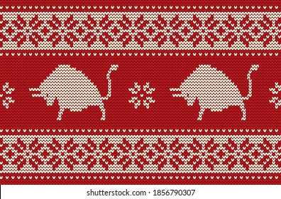 Knitted pattern with bulls. Ornament  in red and white colors. Seamless border. It can be used as a background to the New Year 2021. Year of the Ox. Vector illustration.