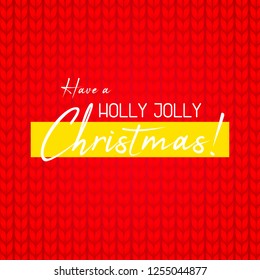 Knitted red background. Sweater close up view with greetings. Have a holly jolly Christmas
