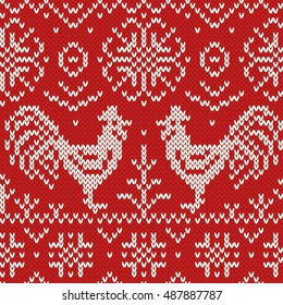 Knitted roosters seamless jacquard pattern. Folk style. Red and white background. Vector illustration.