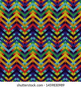 Knitted seamless ornate pattern with zigzag lines in spectrum colors vector as a fabric texture