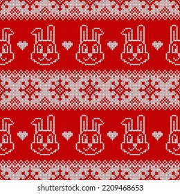 Knitted seamless pattern for 2023 new year of the rabbit. Vector background with cute bunnies, snowflakes and scandinavian ornaments. Red and white sweater print.