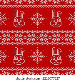 Knitted seamless pattern for 2023 new year of the rabbit. Vector background with cute bunnies, snowflakes and scandinavian ornaments. Red and white sweater print.