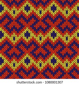 Knitted seamless vector ornate pattern in yellow, red and blue colors as a fabric texture