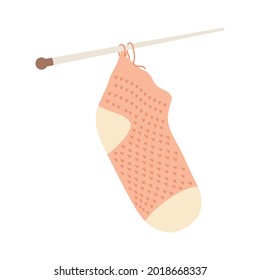 Knitted sock with needles on white background