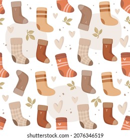 Knitted socks with a variety of patterns. Cozy warm clothes. Leaves, hearts, and dots. Abstract cute background. Vector seamless pattern in a hand-drawn style. Hobby, handmade gifts. Design print.