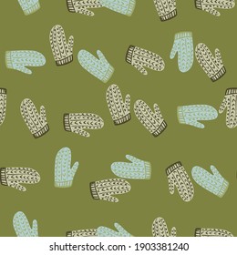 Knitted wool mittens seamless pattern in doodle style. Cozy Christmas clothes with green background. Graphic design for wrapping paper and fabric pattern. Vector Illustration.