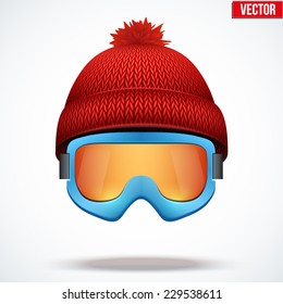 Knitted woolen red cap with snow ski goggles. Winter seasonal sport hat. Vector illustration isolated on white background.