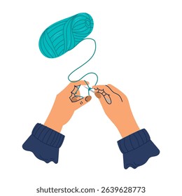 Knitting. Hands hold a knitted fabric on the needles. Hobby, handmade, handicraft.