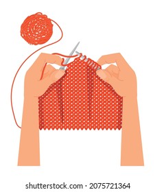 Knitting hobby. Hands with knitting needles and red wool.