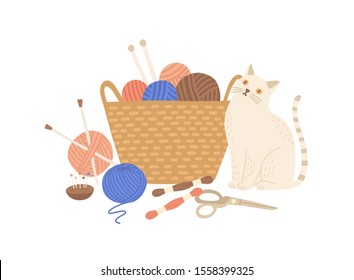 Knitting kit and cute cat flat vector illustration. Adorable animal near basket with yarn balls, needles and scissors. Handcraft equipment, knitwear making accessories isolated on white background.