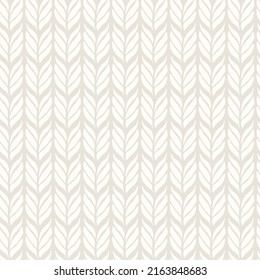 Knitting seamless pattern. Vector background with knitted woolen fabric in light color.